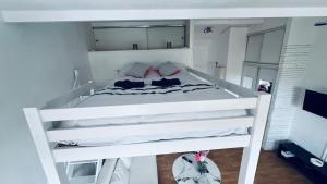 a white bunk bed in a white bedroom at Studio cosy proche de Paris in Drancy