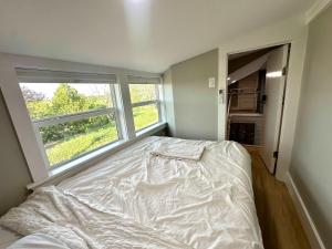 an unmade bed in a bedroom with a window at Tiny Private Room #4 in Shared 5BR House with Other Guests in Austin +13 photos