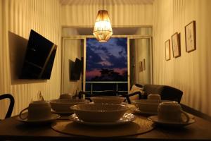 a dining room table with bowls and plates on it at BHB - ApartaHotel in Leticia