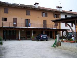 a car parked in front of a large building at b&b da Maria in Fagagna