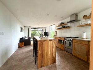a kitchen with a wooden island in a room at Casa Madera 2C in Zacatlán
