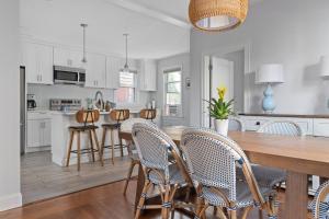 a kitchen and dining room with a wooden table and chairs at Downtown Charming Retreat Newport in Newport