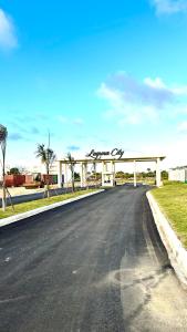an empty road in front of a gas station at Rheia Properties - SANTA FE in Sosúa