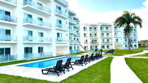 a row of chairs in front of a building at Rheia Properties - SANTA FE in Sosúa +106 photos