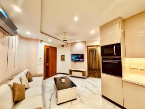 a large living room with a couch and a tv at 2 Bedroom Cozy Apartment by Lux Haven Stays in Lahore