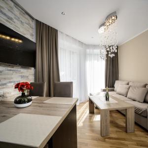 a living room with a table and a couch at Landhaus Ambachhof in Oetz