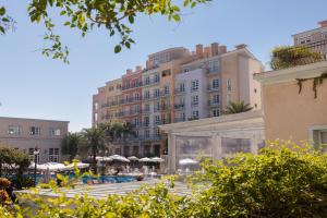 a large building with a pool in front of it at IL Campanário Villaggio Resort Suítes - Jurerê Internacional - Reserva direta com dono in Florianópolis