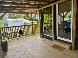 a screened porch with a table and chairs on it at Domek Konik Polny in Jastarnia