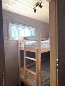 a room with two bunk beds and a window at Domek Konik Polny in Jastarnia