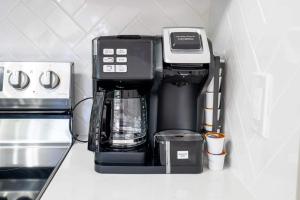 a coffee maker sitting on top of a counter at Casita-stylish Garden Home 5 Min To Bayshore Water in Tampa