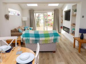 a living room with a couch and a table at Lavender Cottage in Chathill