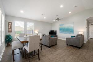 a dining room and living room with a table and chairs at Blue Water Escape in Bolivar Peninsula