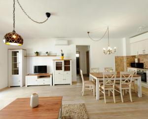 a kitchen and dining room with a table and chairs at Adriatic Escape -Modern Sea View Apartment,Special Summer Deal in Pržno