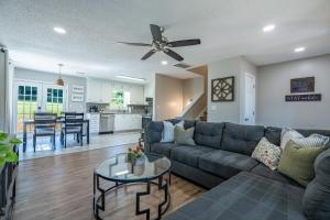 a living room with a couch and a table at Disconnect From The City In This Outdoorsy Getaway in White