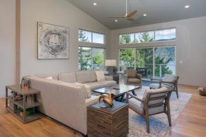 a living room with a couch and a table at Luxury Waterfront & Views, Private Beach, Golfing in Eastsound