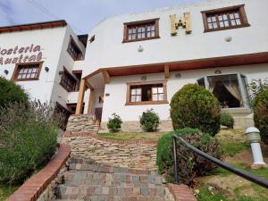 a building with a stone path in front of it at Hostería Austral in El Calafate