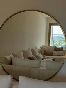 a living room with a white couch and a mirror at Luxury apartment with sea view and 2 pools Sablettes in Mohammedia