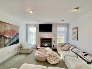 a living room with a couch and a fireplace at Dome Compound with Hot Tub, Piano and Rock-Climbing Gym in New Paltz