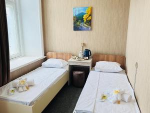 two beds in a small room with at Alina Home Baku hostel in Baku +51 photos