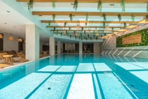a large swimming pool in a building at Joy City Stay Memorandului 5 in Timişoara