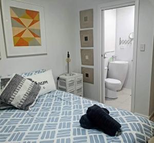 a bedroom with a bed and a bathroom at Coastal Oceanview 2Bedrm 2Bath Pool & Slide! in Perth