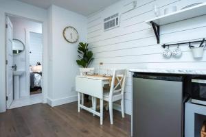 a kitchen with a table and a clock on the wall at Private Escape! Tiny home style in Camas