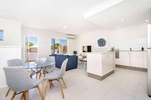 a kitchen and living room with a glass table and chairs at Modern Midland Retreat 2br 1 Bth in Midland Junction