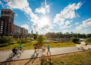 a group of people riding bikes on a sidewalk at <THE MYLO> Walkable | Rooftop | Skyline | Dreamy in Atlanta