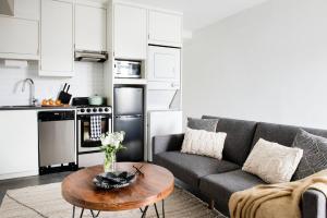 a living room with a couch and a table at <THE MYLO> Walkable | Rooftop | Skyline | Dreamy in Atlanta