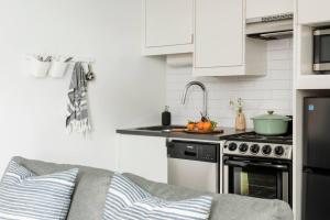 a kitchen with a sink and a stove top oven at <THE MYLO> Walkable | Rooftop | Skyline | Dreamy in Atlanta