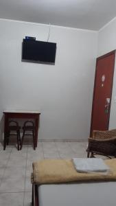 a room with a table and a bench and a desk at Apeninos Suites Basicas in São Paulo +20 photos