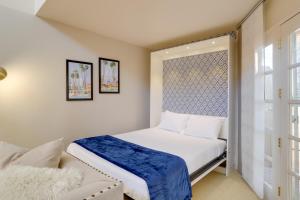 a small bedroom with a bed and a window at Resort Amenities Updated Palm Springs Villa in Palm Springs +22 photos