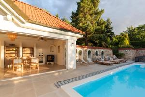 a backyard with a swimming pool and a house at Residence Sodomov in Lhota pod Džbánem