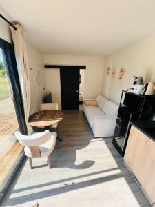 a living room with a couch and a table at Buddha Cottage - PMR in Rosselange