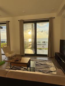 a living room with a view of the ocean at Stunning Oceanview 2B Waterfront Apartement in Bijilo
