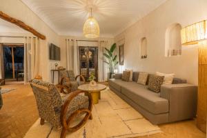 a living room with a couch and a table at Villa Yakout in Ghazoua