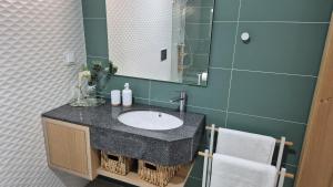 a bathroom with a sink and a mirror at Edifício da Vinha - Ocean Breeze Apartments in Armação de Pêra +47 photos