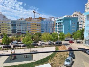 a view of a parking lot in a city at Edifício da Vinha - Ocean Breeze Apartments in Armação de Pêra