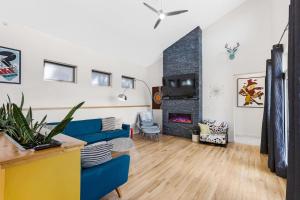 a living room with a blue couch and a fireplace at Mid-century Modern Escape Hikingbiking Nearby! in Salida