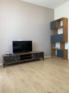 a living room with a flat screen tv on a entertainment center at Apartment for daily rent in Tbilisi City