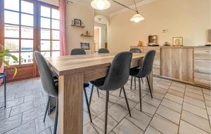 a dining room with a wooden table and chairs at Villa Proche Cévennes in Saint-Hilaire-de-Brethmas