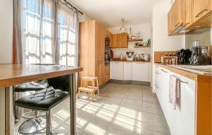 a kitchen with a counter and stools in it at Villa Proche Cévennes in Saint-Hilaire-de-Brethmas