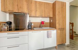 a kitchen with white cabinets and a silver refrigerator at Villa Proche Cévennes in Saint-Hilaire-de-Brethmas +14 photos