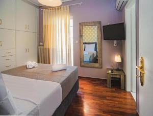 a hotel room with a bed and a mirror at Villa Kazantzaki in Athens +31 photos