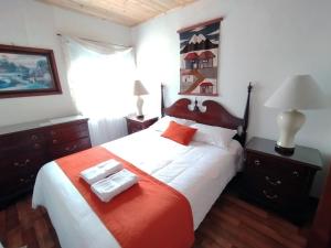 a bedroom with a bed with two trays on it at Alojamiento Rural San Antonio in Ubaté +12 photos