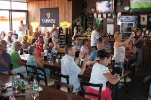 a group of people sitting at tables in a bar at Antonis G. Hotel Apartments in Oroklini +51 photos