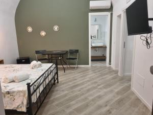 a bedroom with a bed and a table and a dining room at Il borgo in Vico Equense