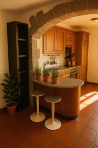 a kitchen with a counter and stools in a kitchen at Casa al Sasso in Bellinzona