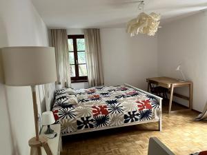 a bedroom with a bed and a lamp and a table at Casa al Sasso in Bellinzona