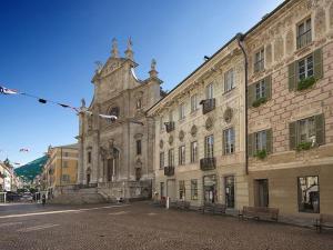 an old building with a clock tower on a street at Casa al Sasso in Bellinzona